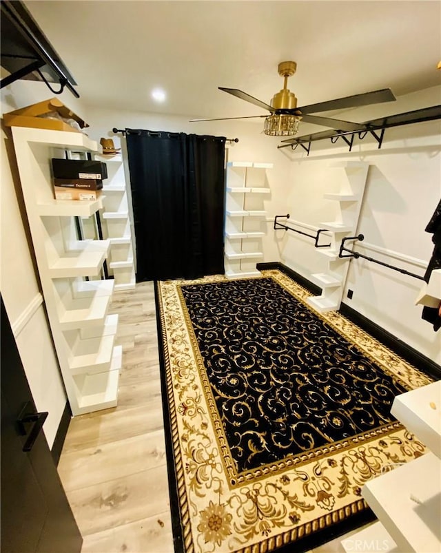 bathroom featuring ceiling fan and wood-type flooring