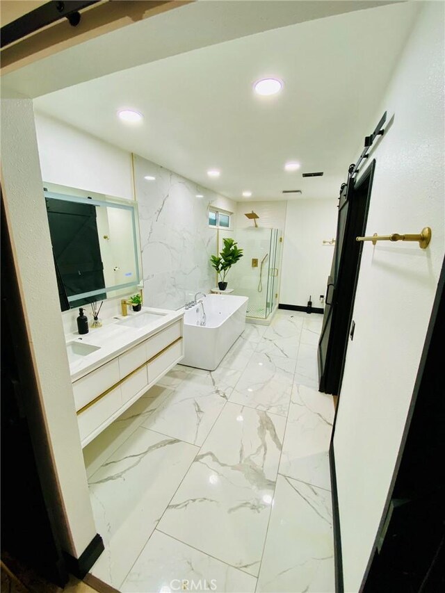 bathroom featuring separate shower and tub and vanity