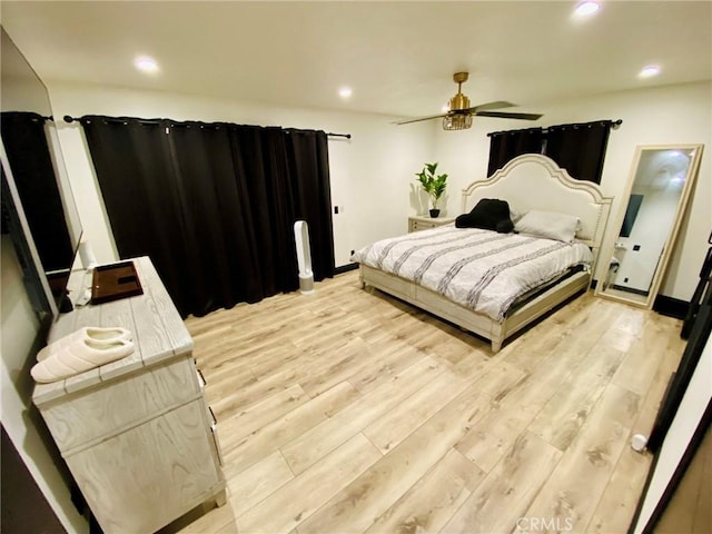 bedroom featuring ceiling fan and light hardwood / wood-style floors