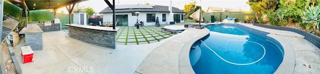 view of pool featuring an outdoor bar