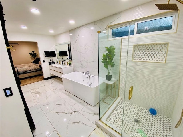 bathroom featuring separate shower and tub and vanity