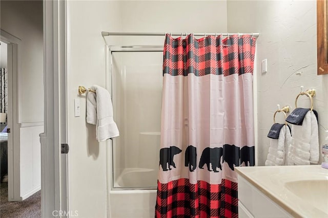 bathroom featuring vanity and shower / bathtub combination with curtain