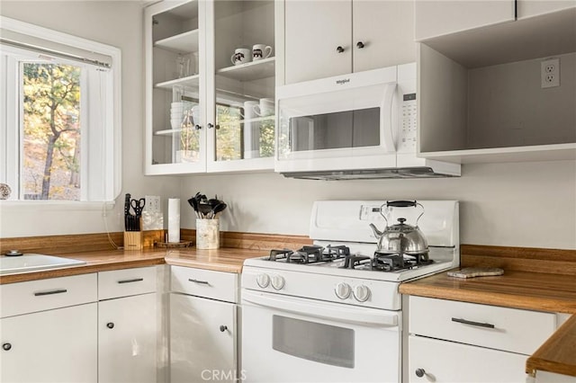 kitchen featuring white cabinets, butcher block countertops, white appliances, and sink