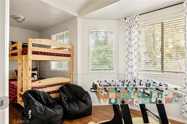 bedroom with wood-type flooring and multiple windows