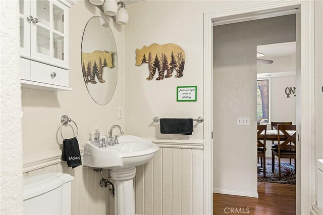 bathroom featuring toilet and wood-type flooring