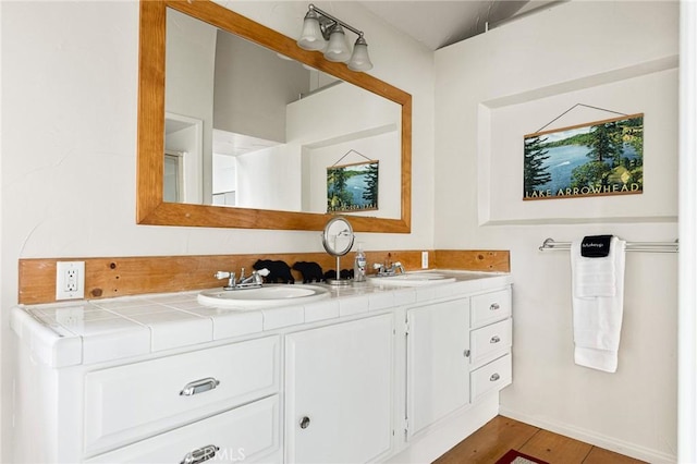 bathroom featuring vanity and hardwood / wood-style flooring