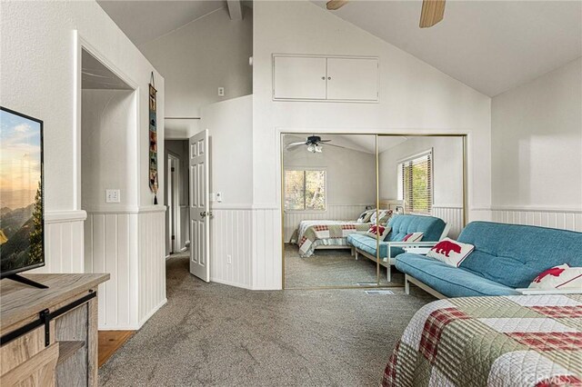 carpeted bedroom featuring ceiling fan, a closet, and lofted ceiling