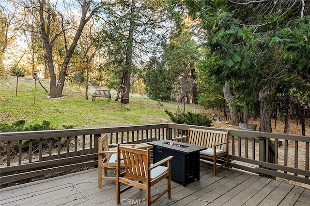 deck featuring a yard and a fire pit