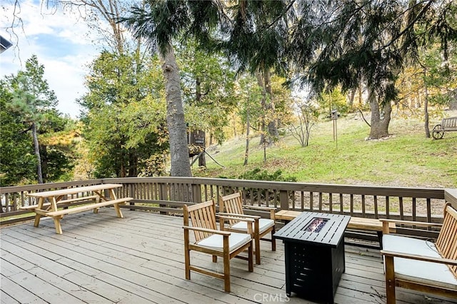 wooden terrace featuring an outdoor fire pit