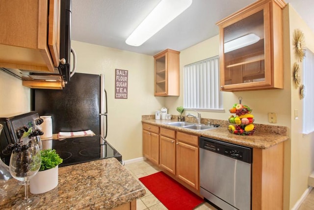 kitchen with light stone countertops, light tile patterned floors, stainless steel appliances, and sink