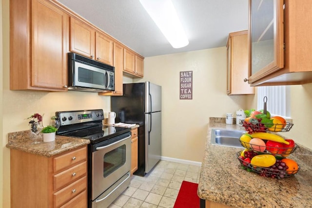 kitchen with light stone counters and stainless steel appliances