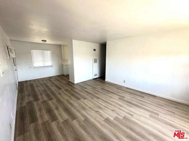 spare room with wood-type flooring