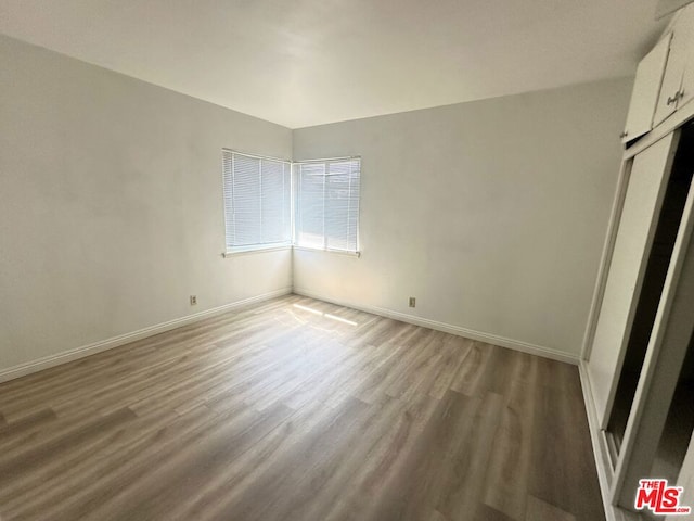 unfurnished bedroom with wood-type flooring