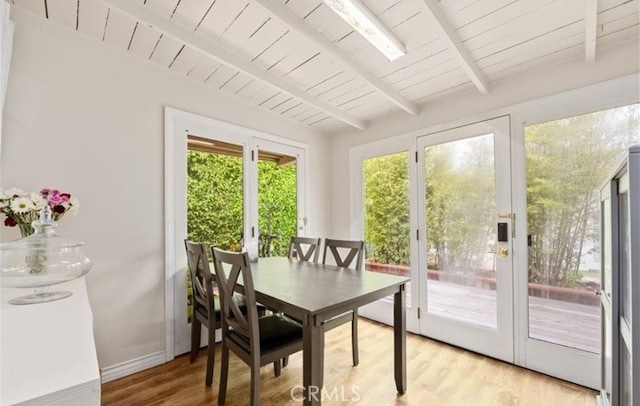 sunroom with french doors, plenty of natural light, wooden ceiling, and lofted ceiling with beams