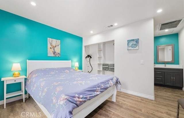 bedroom with hardwood / wood-style floors and a closet