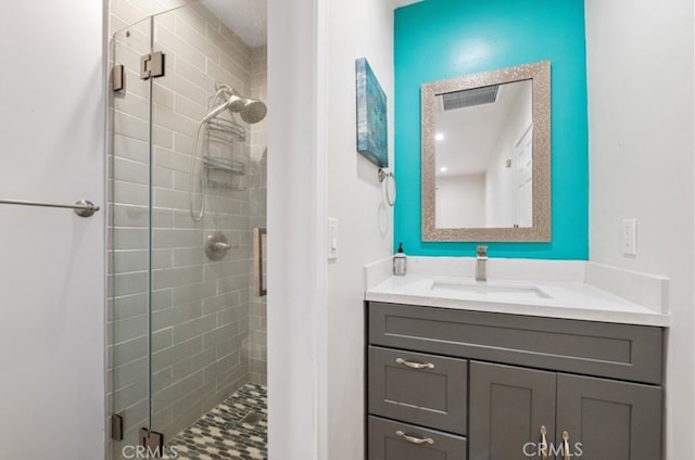 bathroom with walk in shower and vanity