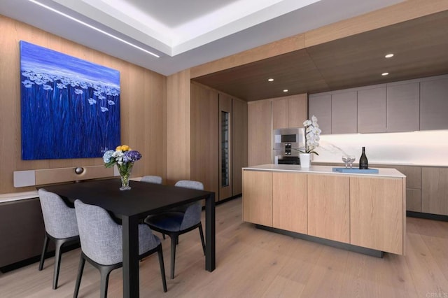 kitchen featuring light brown cabinets, light wood-type flooring, and a center island