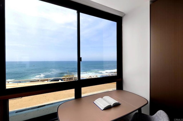 interior space featuring a water view and a beach view