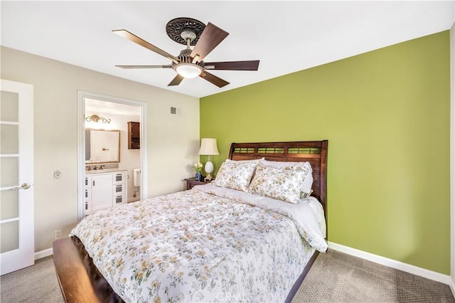 bedroom featuring ensuite bathroom, ceiling fan, and carpet floors