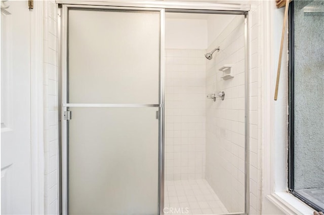 bathroom with a shower with door