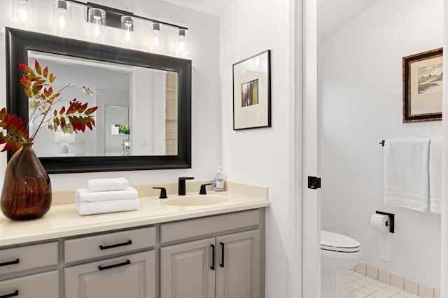 bathroom with vanity, tile patterned flooring, and toilet