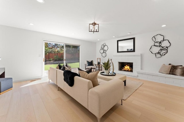 living room featuring a fireplace and light hardwood / wood-style flooring