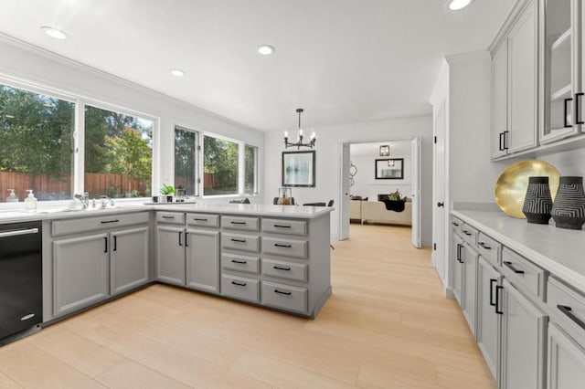 kitchen with pendant lighting, ornamental molding, gray cabinetry, and black dishwasher