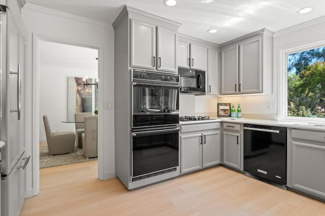 kitchen featuring crown molding, gray cabinets, and black appliances