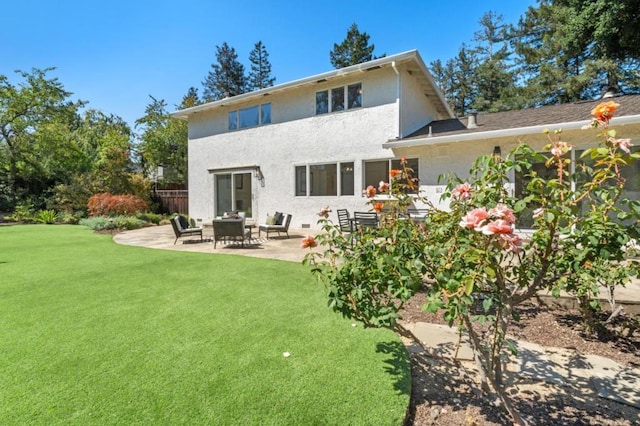 back of property featuring a patio and a lawn