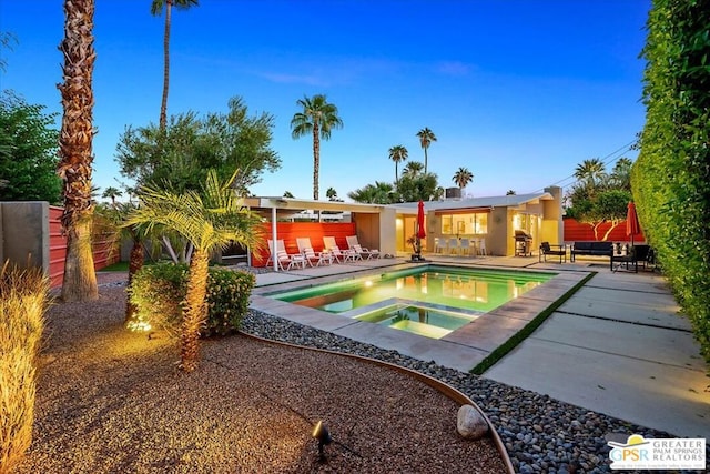 view of pool featuring an in ground hot tub and a patio