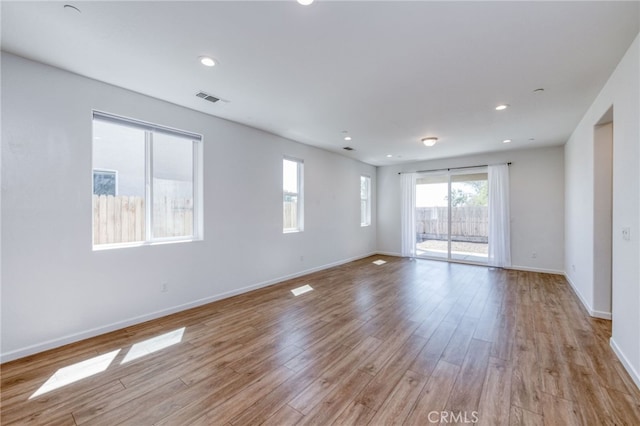 spare room featuring light hardwood / wood-style floors