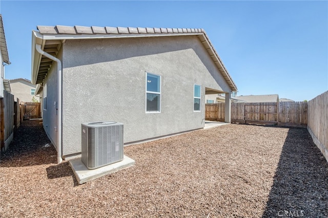 rear view of property with cooling unit