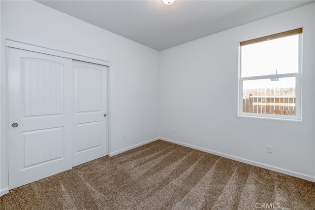 unfurnished bedroom featuring carpet floors and a closet