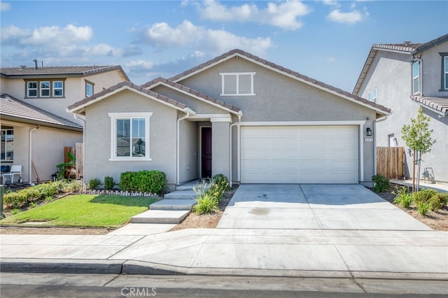 view of front of property featuring a front yard and a garage