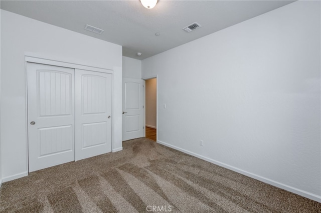 unfurnished bedroom featuring a closet and carpet flooring