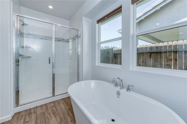 bathroom featuring wood-type flooring and independent shower and bath