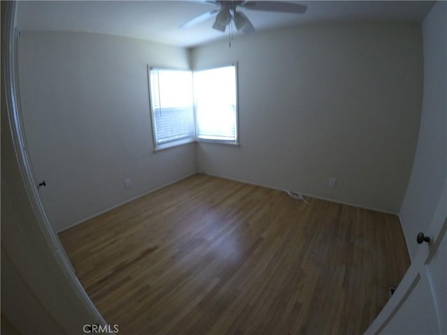 spare room featuring a ceiling fan and wood finished floors