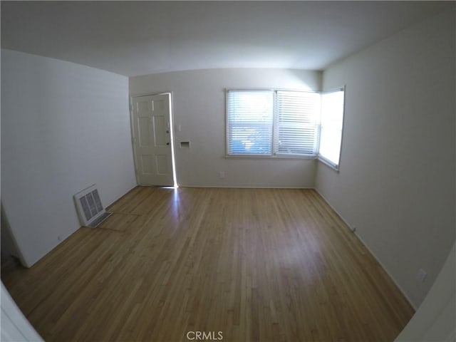 spare room with visible vents and wood finished floors