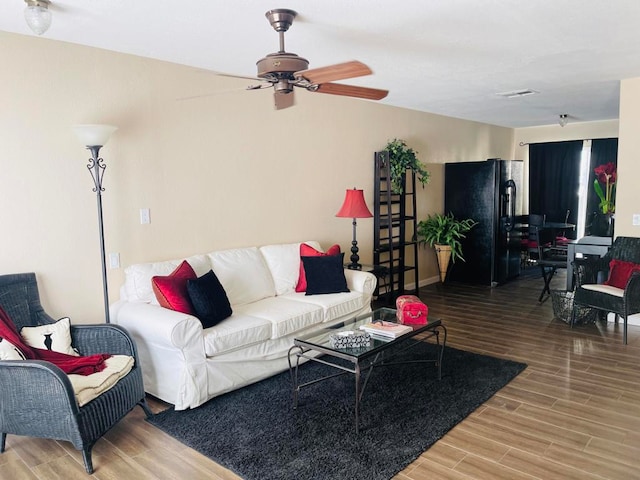 living room with ceiling fan and wood-type flooring