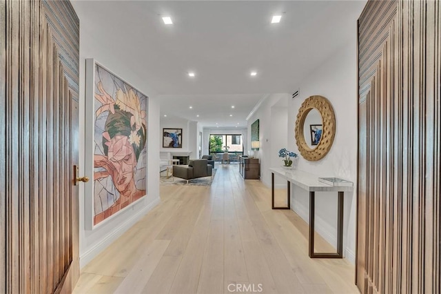 hallway with light hardwood / wood-style floors