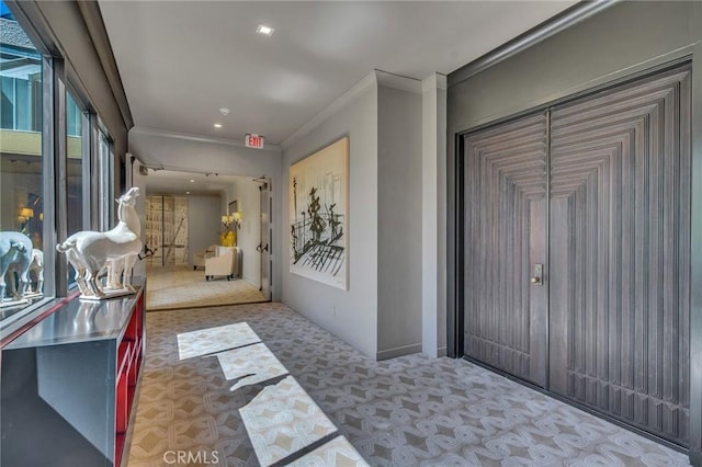 hallway featuring light colored carpet and ornamental molding