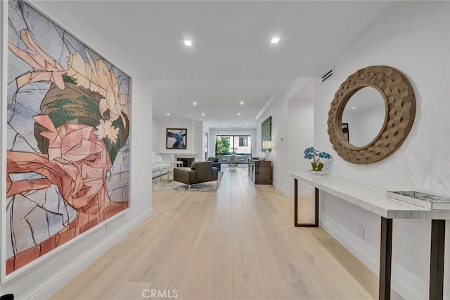 corridor with light hardwood / wood-style flooring