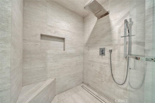 bathroom with tiled shower