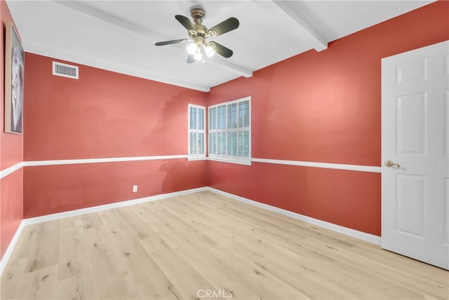 unfurnished room with beam ceiling, light hardwood / wood-style flooring, and ceiling fan