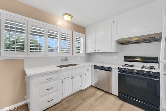 kitchen featuring black gas range, a healthy amount of sunlight, sink, and stainless steel dishwasher