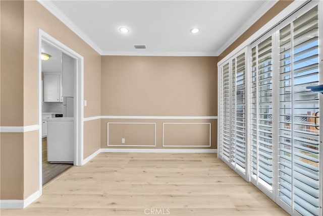 interior space featuring light wood-type flooring and ornamental molding