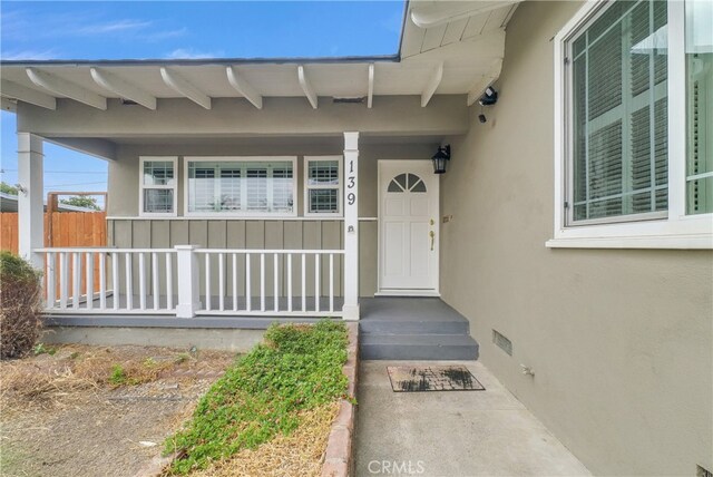 doorway to property featuring a porch