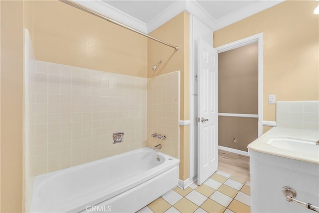 bathroom featuring tile patterned floors, vanity, tiled shower / bath combo, and ornamental molding