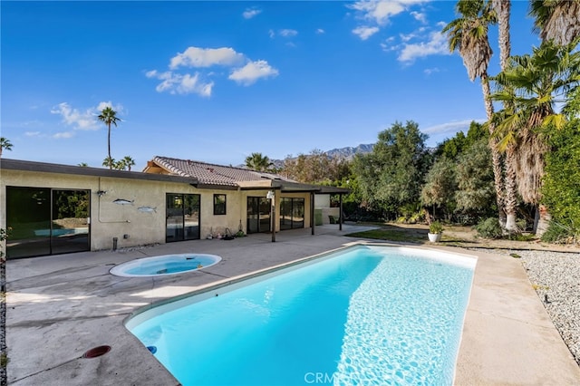 view of pool with an in ground hot tub and a patio