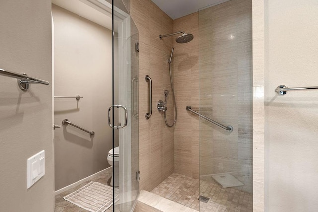 bathroom with an enclosed shower and toilet